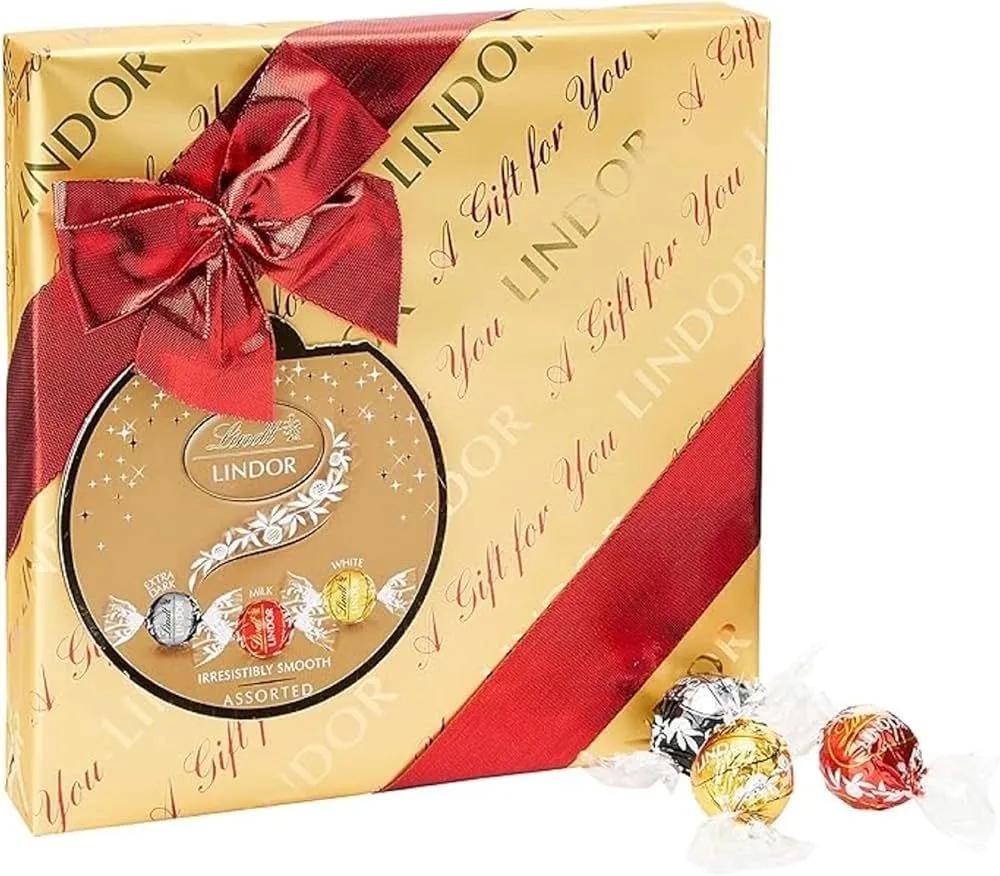 Конфеты Lindt lindor ассорти assorted gift box золотая подарочная с бантом 287 гр., картон